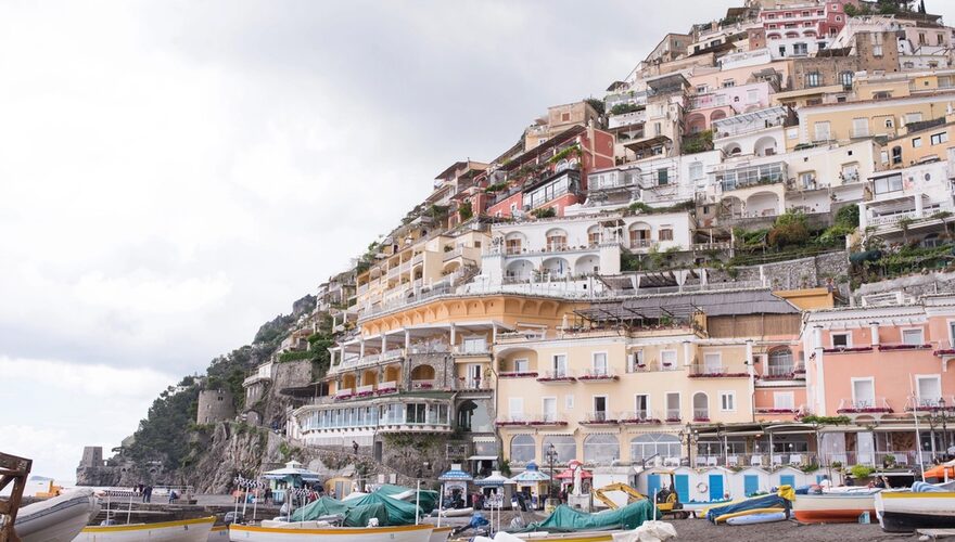 Pastel houses stacked up the cliffside above the harbour in Positano on the Amalfi Coast