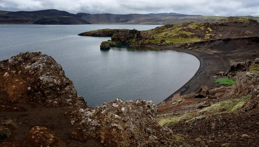 Quiet volcanic shoreline and mossy lava rock along Lake Kleifarvatn in Iceland